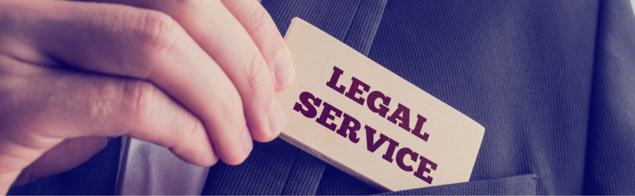 Man's hand hold card with Legal Service printed on it.